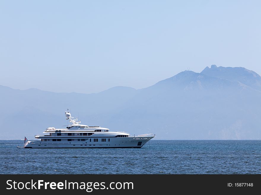 Large white motor yacht anchored in the bay mountain. Large white motor yacht anchored in the bay mountain
