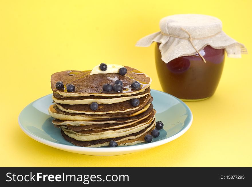 Stack of homemade pancakes with syrup and berries