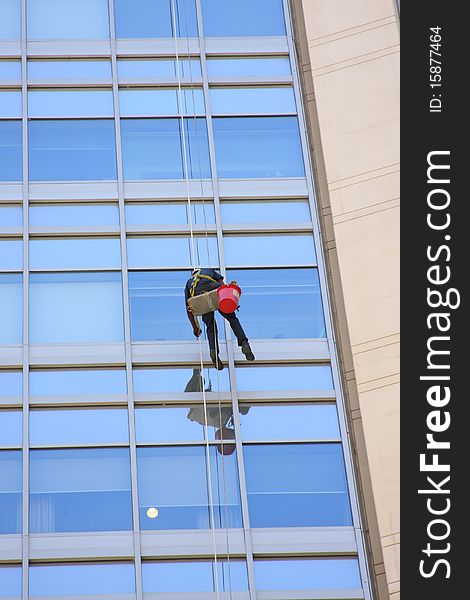 Window washer and a glass wall