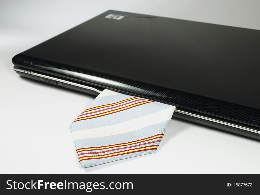 Black notebook with blue tie on the white background