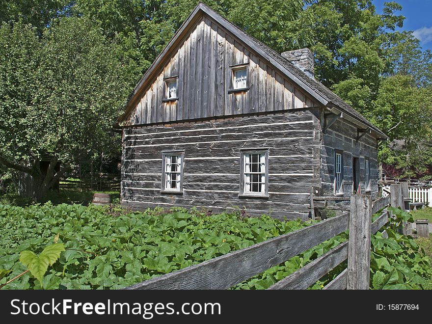 19th century farmhouse with squash garden in Eastern Canada. 19th century farmhouse with squash garden in Eastern Canada