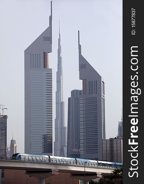 Emirates towers and burj dubai with metro