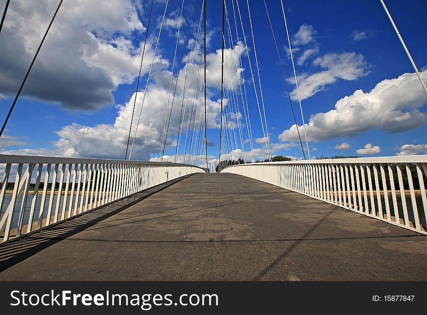 Modern bridge with blue sky and many clouds. Modern bridge with blue sky and many clouds