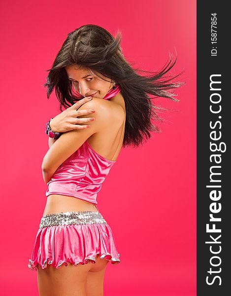 Sensual brunette girl posing on color background