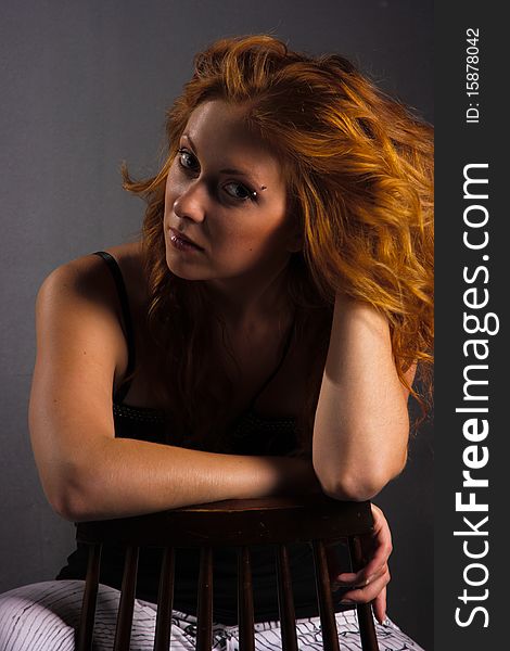 Portrait of beautiful redhaired woman on a dark background. Portrait of beautiful redhaired woman on a dark background
