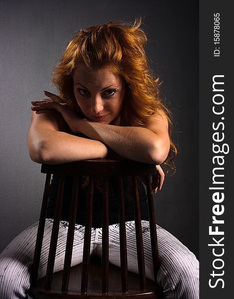 Portrait of beautiful red haired woman on a dark background. Portrait of beautiful red haired woman on a dark background