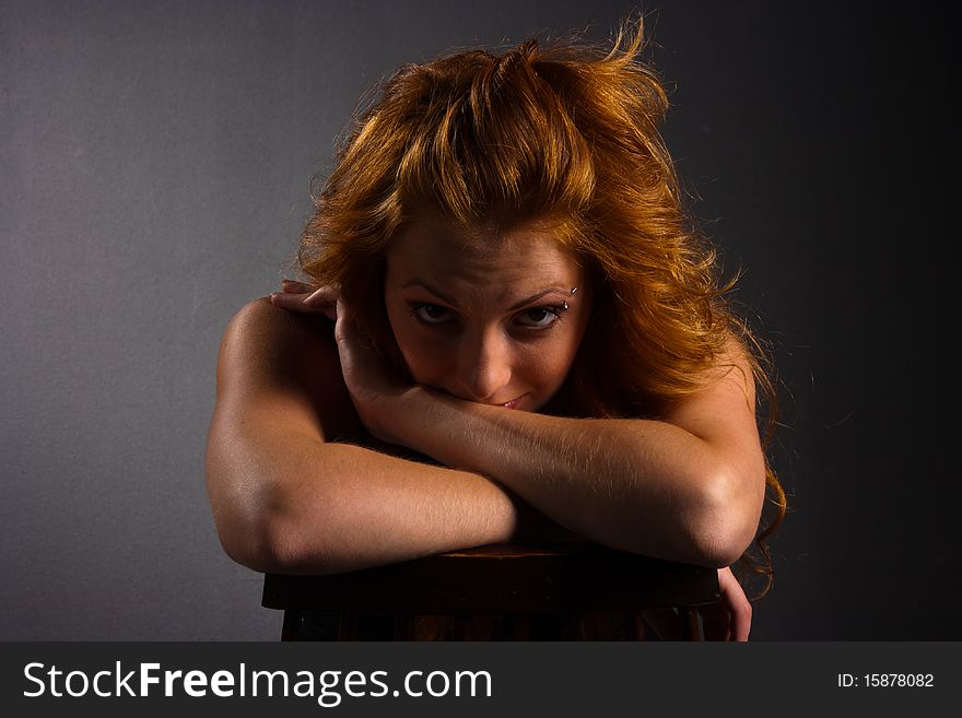 Portrait of beautiful red-haired woman on a dark background. Portrait of beautiful red-haired woman on a dark background