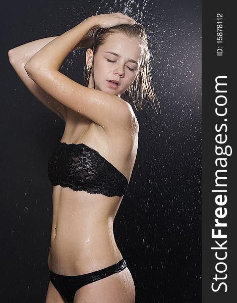 A young attractive woman is covered with dripping water. A young attractive woman is covered with dripping water.