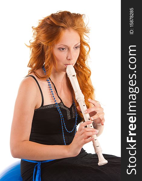 Young woman with red hair who plays the flute. Young woman with red hair who plays the flute