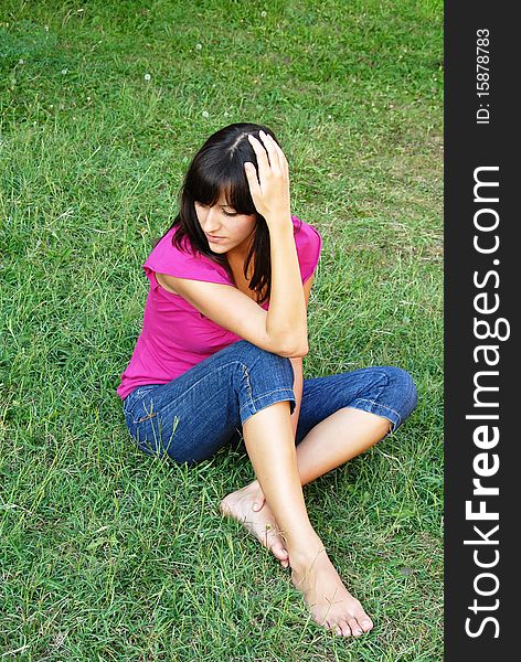 Young Woman Sitting On Grass