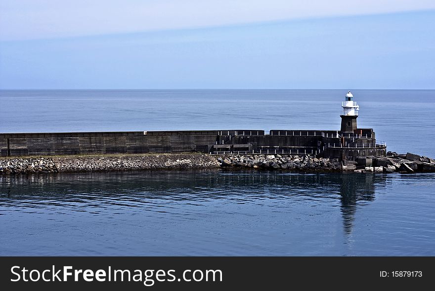 A pier with a lighthouse at the end