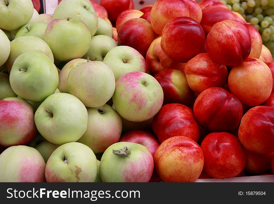 Fresh apples and nectarines on fruit market
