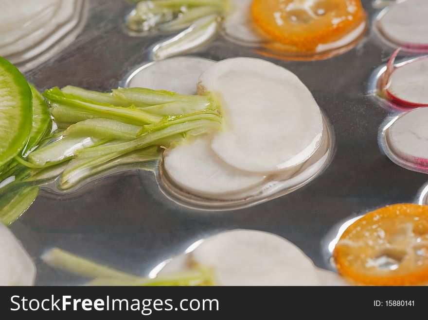 Picture of various vegetables floating in water