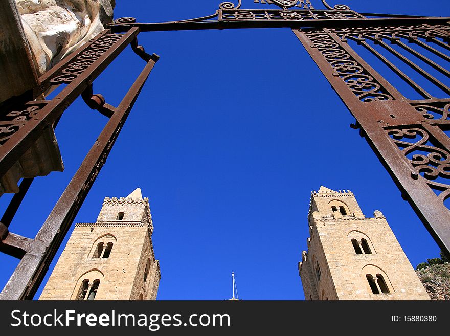 Cefalu ancient norman cathedral towers on blue summer sky, Island of Sicily - Italy. Cefalu ancient norman cathedral towers on blue summer sky, Island of Sicily - Italy