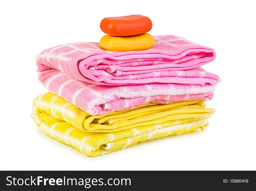 Towels and piece of soap isolated on white background. Towels and piece of soap isolated on white background