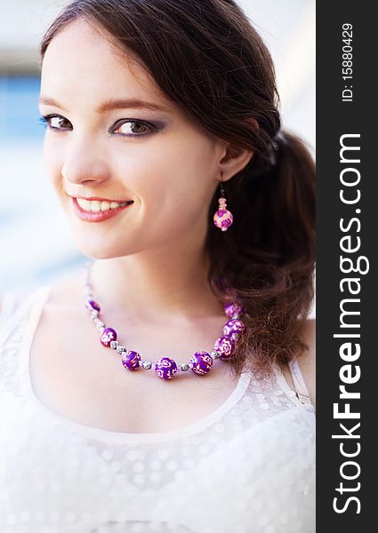 Portrait of a happy young laughing girl wearing beads