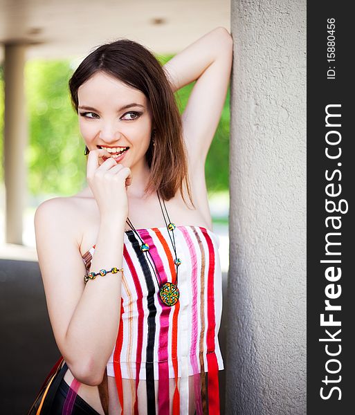 Portrait of a beautiful young brunette model wearing beads