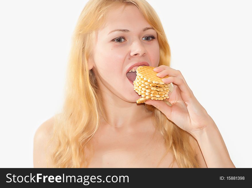 Young attractive girl tries to eat at once some waffle. Young attractive girl tries to eat at once some waffle