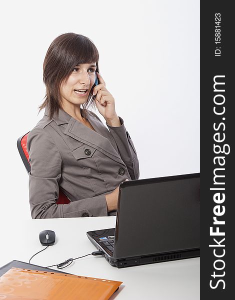 This photo shows a business woman talking on the phone.