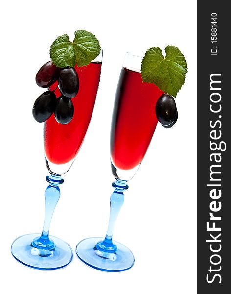 Red wine in glasses with grapes. Isolated on white background. Red wine in glasses with grapes. Isolated on white background