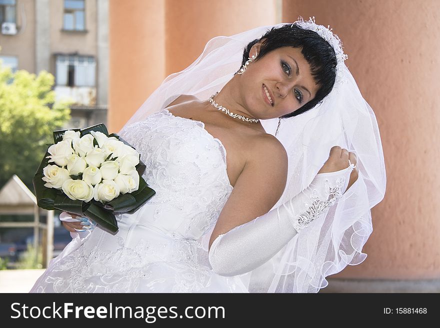 One happy bride a bouquet outdoors.