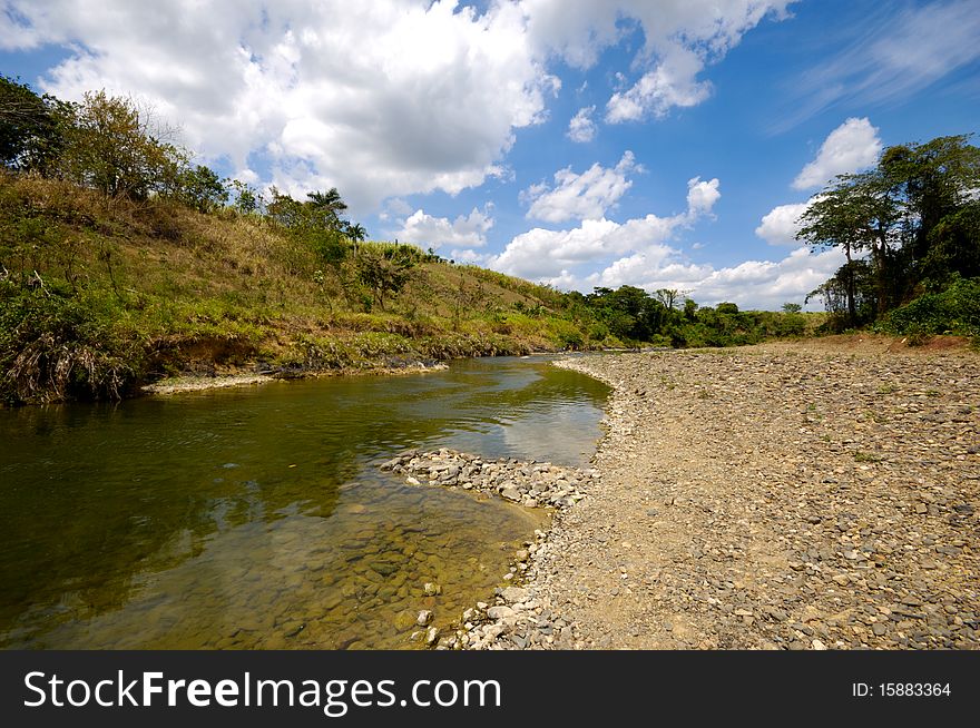 River and green nature with white clouds. Dominican Republic. River and green nature with white clouds. Dominican Republic.