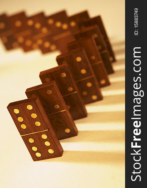 Row of wooden dominoes standing up