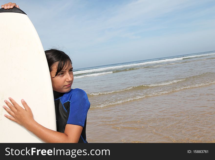 Young girl with surfboard on the beach. Young girl with surfboard on the beach