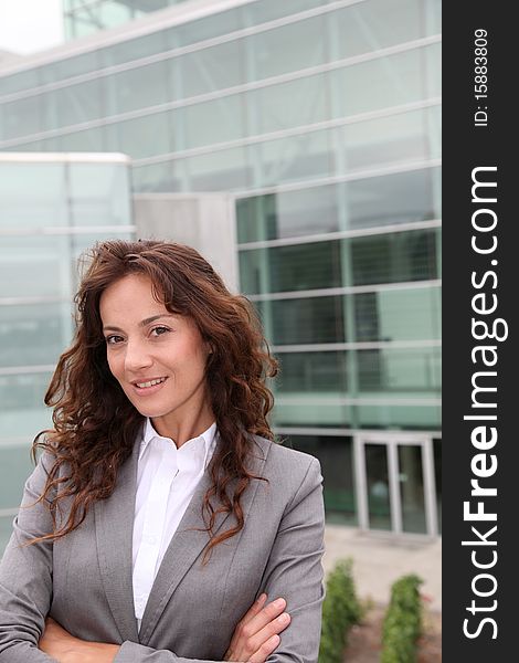 Businesswoman standing in front of modern building. Businesswoman standing in front of modern building