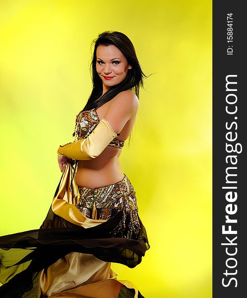 Beautiful dancer woman in bellydance costume with pretty professional stage make-up