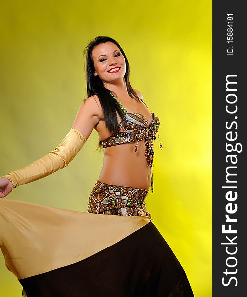 Beautiful dancer woman in bellydance costume with pretty professional stage make-up