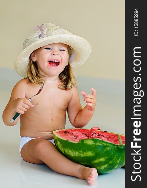 Funny cute girl in hat eating with appetite ripe watermelon. Funny cute girl in hat eating with appetite ripe watermelon