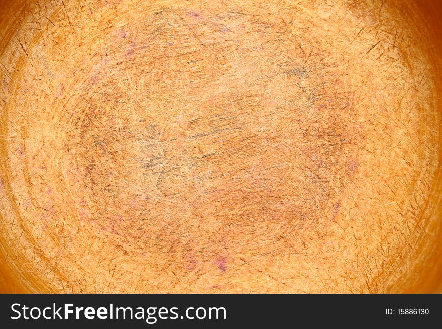 The bottom of an old wooden bowl, used for chopping vegetables, can be used as a background. The bottom of an old wooden bowl, used for chopping vegetables, can be used as a background.