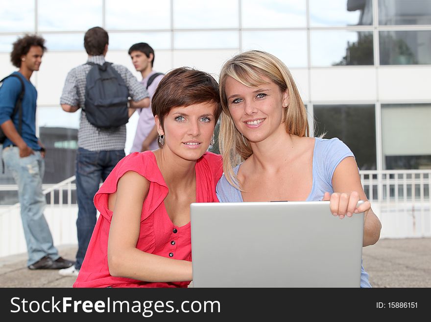 Students at college campus with laptop computer. Students at college campus with laptop computer