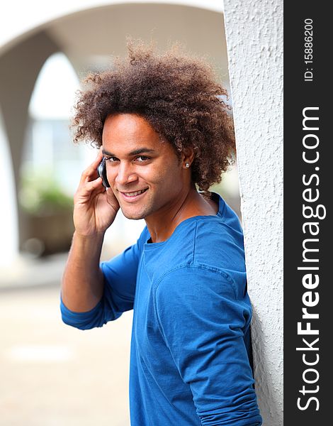 Young man with blue shirt talking on the phone