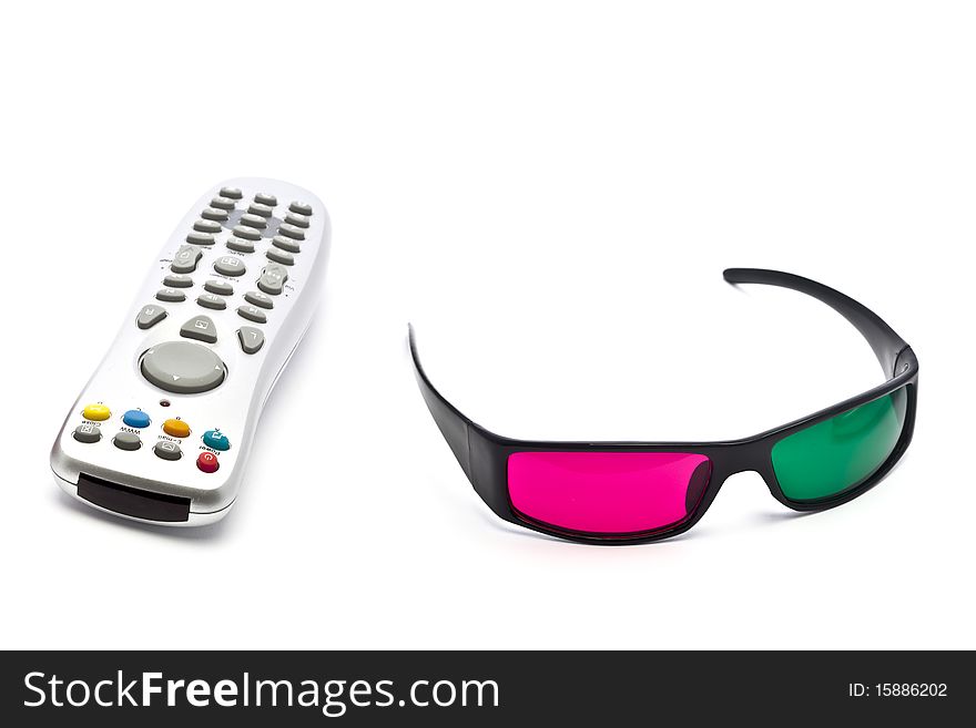 A pair of anaglyph 3D glasses and remote control on a white background. A pair of anaglyph 3D glasses and remote control on a white background.