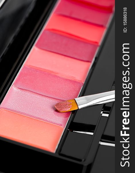 Palette of lipsticks with cosmetic brush