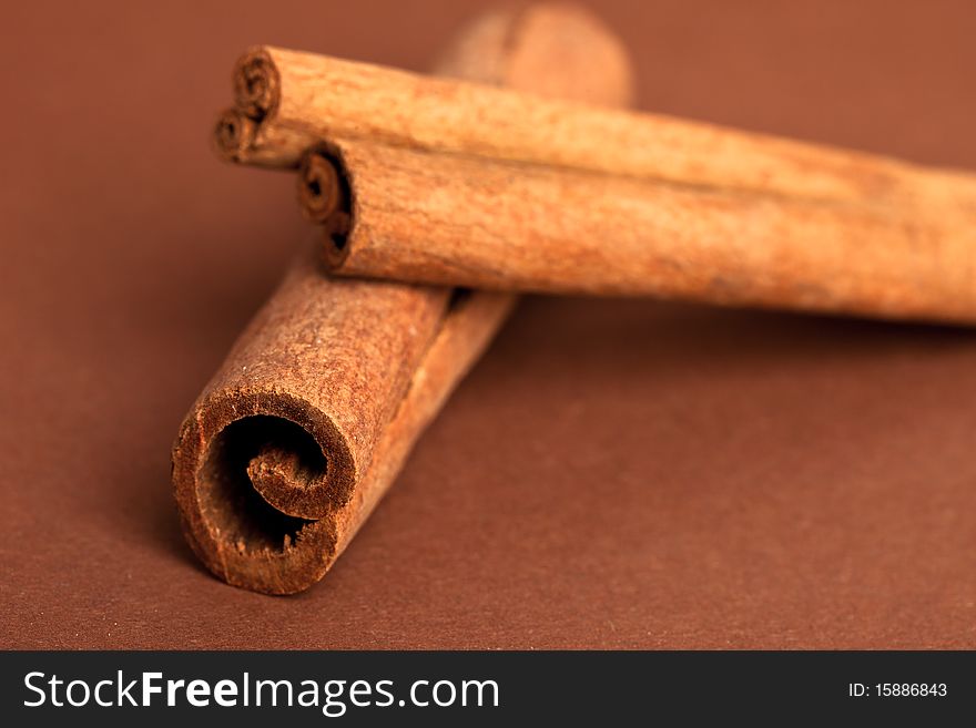 Cinnamon sticks on brown background