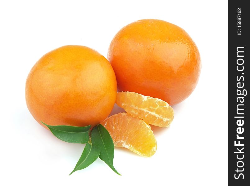 Tangerines entirely and segments and with leaves close up. Tangerines entirely and segments and with leaves close up
