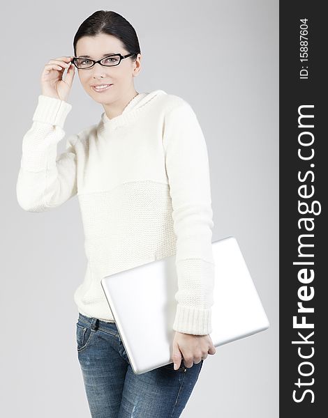 Portrait of a young woman holding a laptop computer, businesswoman or student. Portrait of a young woman holding a laptop computer, businesswoman or student