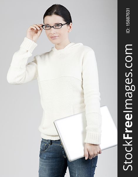 Portrait of a young woman holding a laptop computer, businesswoman or student. Portrait of a young woman holding a laptop computer, businesswoman or student