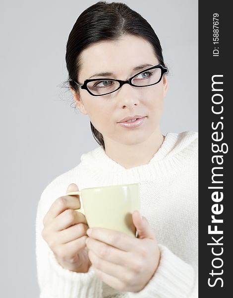 Young woman holding a cup of coffee/tea. Young woman holding a cup of coffee/tea