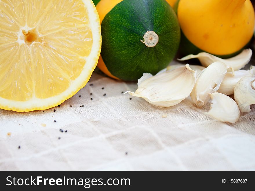 Little pumpkins and lemon on kitchen plot