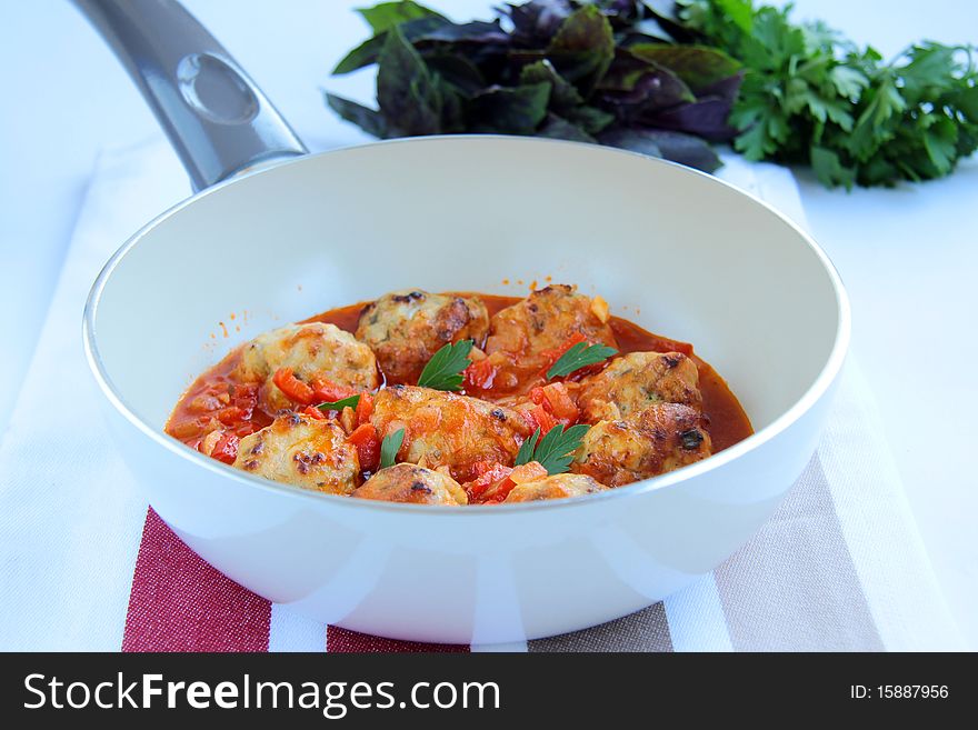 Meat sauce in the pan with greens and a napkin. Meat sauce in the pan with greens and a napkin