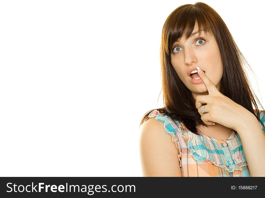 Close-up of a young woman looking surprised on white background