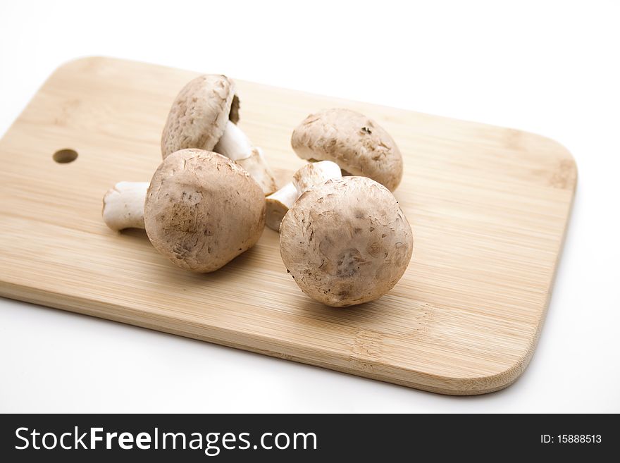 Champignon mushrooms on edge board