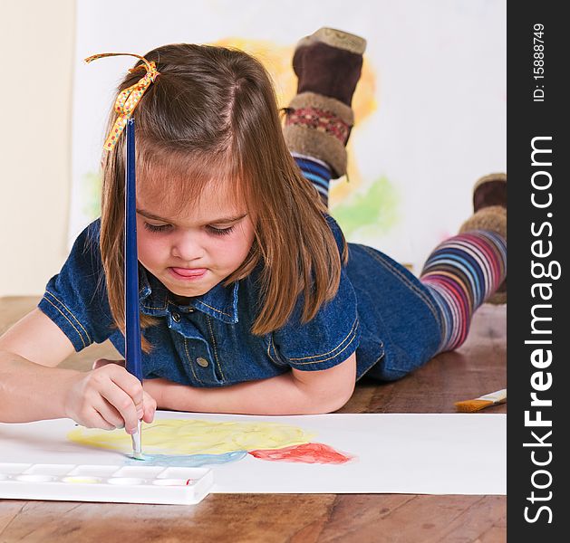 Young girl concentrating on her painting. Young girl concentrating on her painting