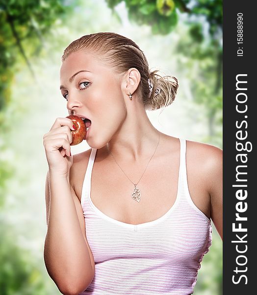 Portrait of young beautiful woman biting apple on color back. Portrait of young beautiful woman biting apple on color back