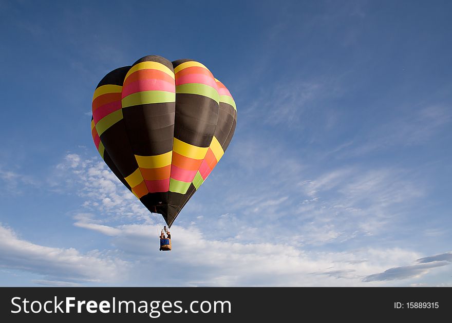 A solitary balloon drifts through the morning sky above Colorado Springs Balloon Classic. A solitary balloon drifts through the morning sky above Colorado Springs Balloon Classic.