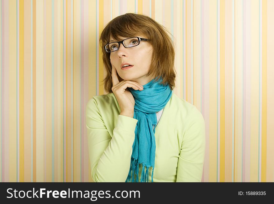 Beautiful young woman in glasses thinking. Beautiful young woman in glasses thinking